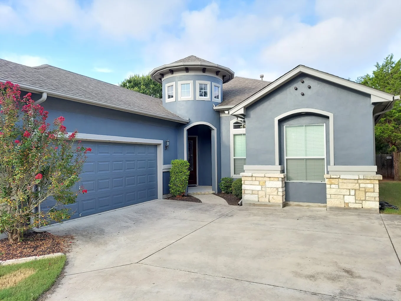 Full exterior house painting in blue-gray with turret detail